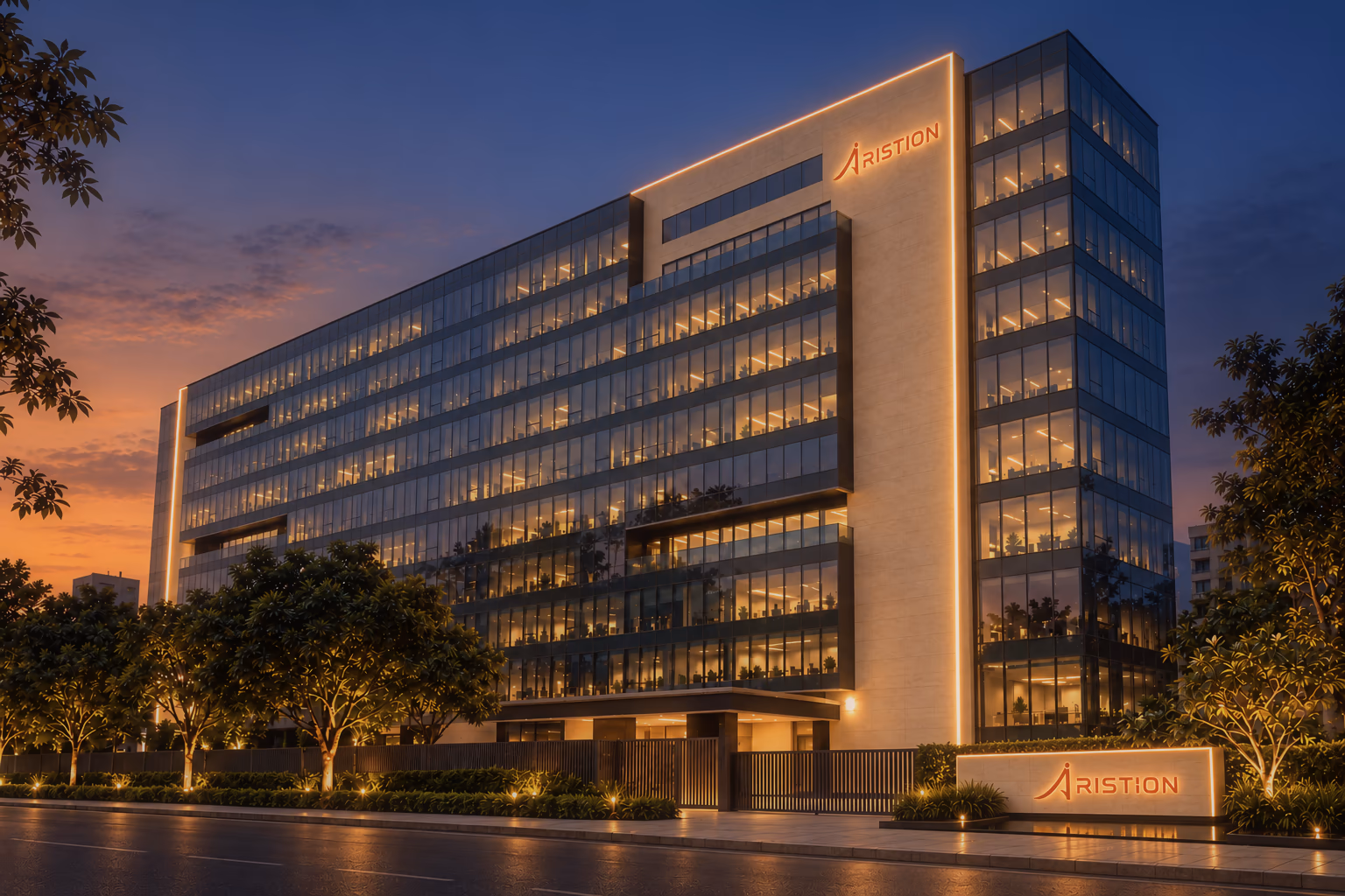 The Aristion building on Airport Road at dusk, every floor glowing amber, a single amber line tracing its stone fin, the Aristion name lit above and the name board glowing at the gate.